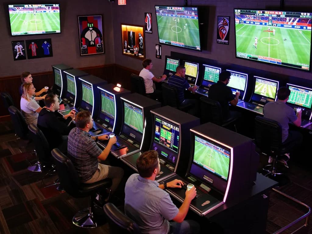 Engaging sportsbook scene where ATQ members are actively placing bets during live events, capturing the vibrant atmosphere.
